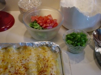 Preparing the salad for the enchilada: Diced tomato, lettuce, green onions